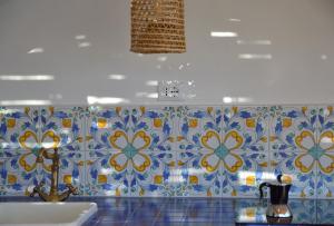 a bathroom with blue and white tiles on the wall at Terrazza Aragonese in Ischia Town