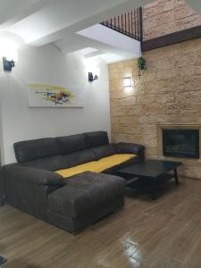 a living room with a couch and a fireplace at Casa Bonaire in Chella