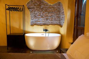 a bathroom with a bath tub on a wall at Rustico di charme in Fiano Romano