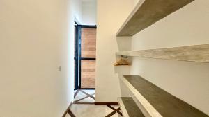 a staircase in a house with a window at Canggu Villa - 7BR Private Cook, Pool, Rooftop Cinema in Canggu +19 photos