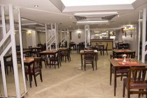 a dining room with wooden tables and chairs at Oscar Hotel Aswan 中國人之家 in Aswan