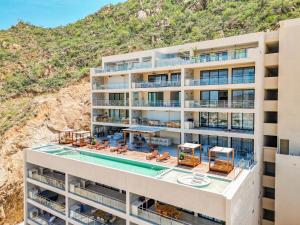 an aerial view of a building with a swimming pool at Luxury Pedregal Condo - Views, Pool & Concierge in Cabo San Lucas