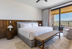 a bedroom with a large bed and a couch at Luxury Pedregal Condo - Views, Pool & Concierge in Cabo San Lucas +62 photos