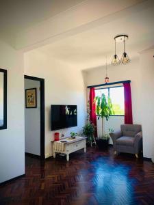 a living room with a tv and a couch and a table at Charming flat with big private Terrace in Montevideo