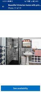 a picture of a bathroom with a sink and a table at Holyhead Ferry Stay in Holyhead