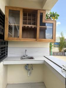 a kitchen counter with a sink and a window at Villa Sol Odalis in Jarabacoa