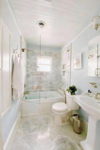 a bathroom with a tub and a toilet and a sink at Breckenridge Alpine Residence in Breckenridge