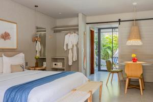 a bedroom with a bed and a table and chairs at Saline Taíba Boutique Beach Hotel in Taíba