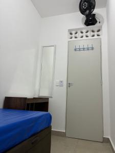 a room with a white refrigerator and a mirror at Condomínio Itaparica III in Guarujá +21 photos