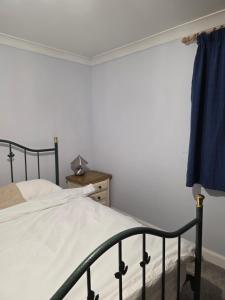 a bedroom with a bed and a dresser at Essex studio x2 in Hythe