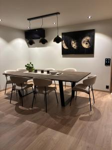 a dining room with a table and some chairs at House with parking and view in Harstad