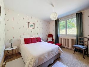 a bedroom with a large bed and a window at chez Anne in Tanlay