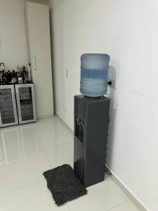 a blue bucket sitting on top of a refrigerator at Moderna casa en barrio tranquilo in Villa Ángela