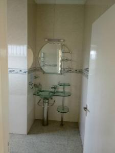 a bathroom with a sink and a mirror at John residence in Accra