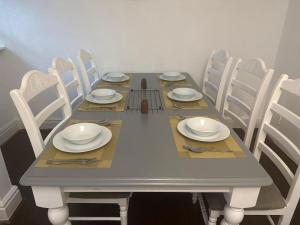 a table with white plates and silverware on it at Cambridge House in Manchester +11 photos