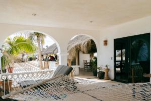 a room with a hammock on a patio at Liebre Matrera in San José del Cabo