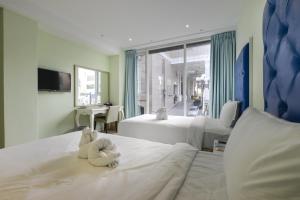 Ένα ή περισσότερα κρεβάτια σε δωμάτιο στο Lion King Hotel