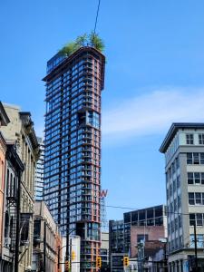 a tall building with a tree on top of it at Luxury Downtown Vancouver Suite in Vancouver