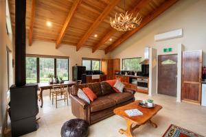 a living room with a couch and a table at Bruny Island Haven in Adventure Bay +2 photos