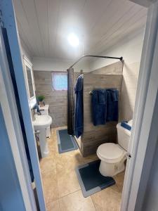 a small bathroom with a toilet and a sink at All Decked Out, Exuma in Georgetown +35 photos