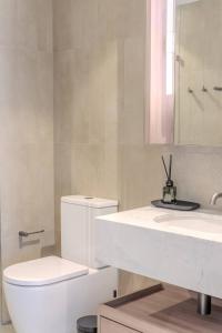 a bathroom with a white toilet and a sink at Sky Palace — Luxe Queen’s Wharf Apt + Carpark in Brisbane +32 photos