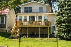 a house with a large deck on the front of it at Family-Friendly Lakehouse with Firepit and Dock in Warsaw +25 photos