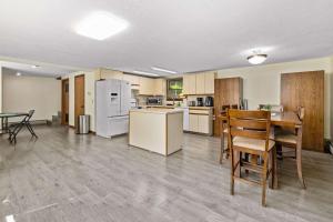 a kitchen and dining room with a table and chairs at Family-Friendly Lakehouse with Firepit and Dock in Warsaw