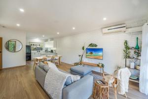 a living room with a couch and a table at Cozy Newtown 2 bedroom unit in Geelong