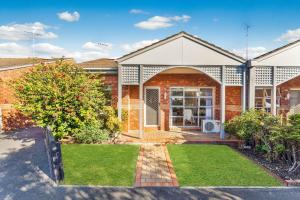 a brick house with an open door and a yard at Cozy Newtown 2 bedroom unit in Geelong +9 photos
