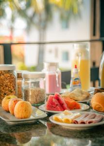 a table with plates of food on top at Pecem Beach Hotel - Aval Hotel in Pecém