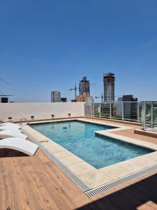 a swimming pool on the roof of a building at Houze 208 in Asuncion