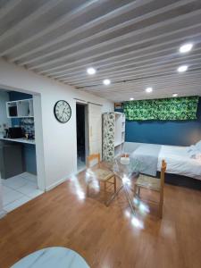 a bedroom with a bed and a table and a clock at AtTheDeck in Pietermaritzburg