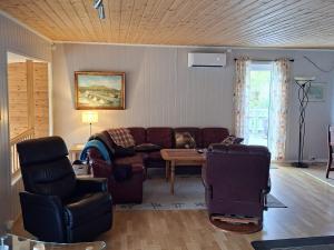 a living room with a couch and a table at 7 person holiday home in Grovfjord in Kovan