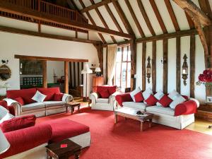 a large living room with couches and a red rug at Doves Barn in Needham Market +29 photos
