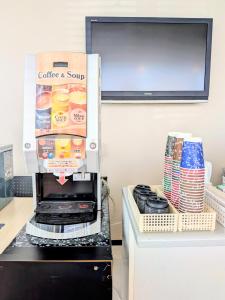 a coffee machine with a box on top of a refrigerator at Sakura Hotel Oami in Oamishirasato +22 photos
