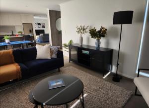 a living room with a couch and a table at The Keenans in Whitianga