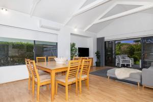 a dining room with a wooden table and chairs at The Enclave - A Family Alfresco Retreat in Dunsborough
