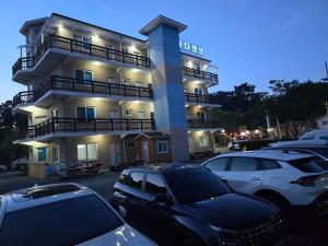 a large building with cars parked in front of it at Seocheon Bada Pension in Seocheon