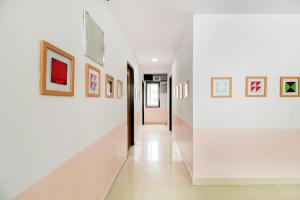 Hotel O PRAMOD PRIME HOMES في Surūrnagar: مدخل منزل به لوحات على الجدران