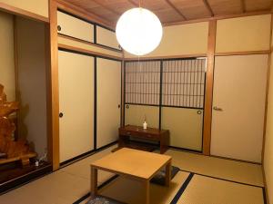 a room with a table and a room with doors at Hidamari in Takayama +24 photos
