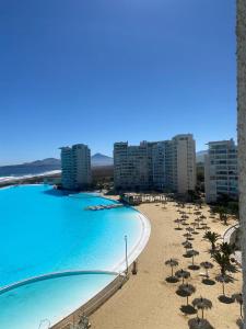 a view of a beach with umbrellas and buildings at departamento con vista al mar en La Serena in La Serena