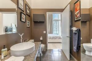 a bathroom with a tub and a sink and a toilet at Beautiful Icon Brickell Double height ceiling in Miami +19 photos