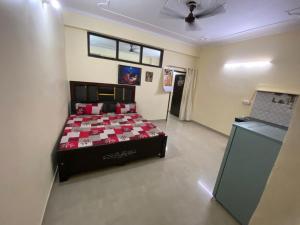 a bedroom with a bed in the middle of a room at Gopiess in Vrindāvan