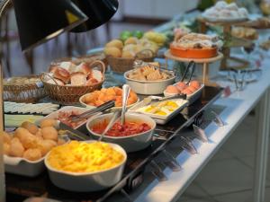 a buffet with many different types of food on a table at Pousada Vila do Coral in Bombinhas