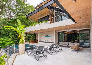 a house with a pool and a patio at NEW Modern 6BR, Pool, Walk 2 Beach, Sleeps 20 in Playa Guiones