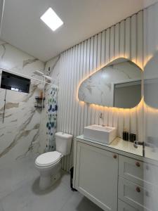 サン・フランシスコ・ド・スルにあるErvino Sunsetのトイレと洗面台を備えた白いバスルーム