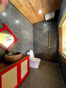 a bathroom with a sink and a toilet in it at Alley Homestay SaPa in Sa Pa