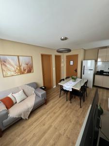 a living room with a couch and a table at Novo, decorado e perto de tudo in Ananindeua