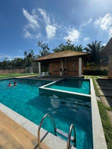 a swimming pool in front of a house at Novo, decorado e perto de tudo in Ananindeua
