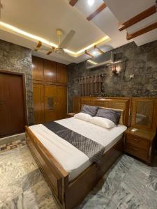a bedroom with a large bed in a room at Travellers Home 2BR PORTION Gulshan Iqbal blk#7 in Karachi